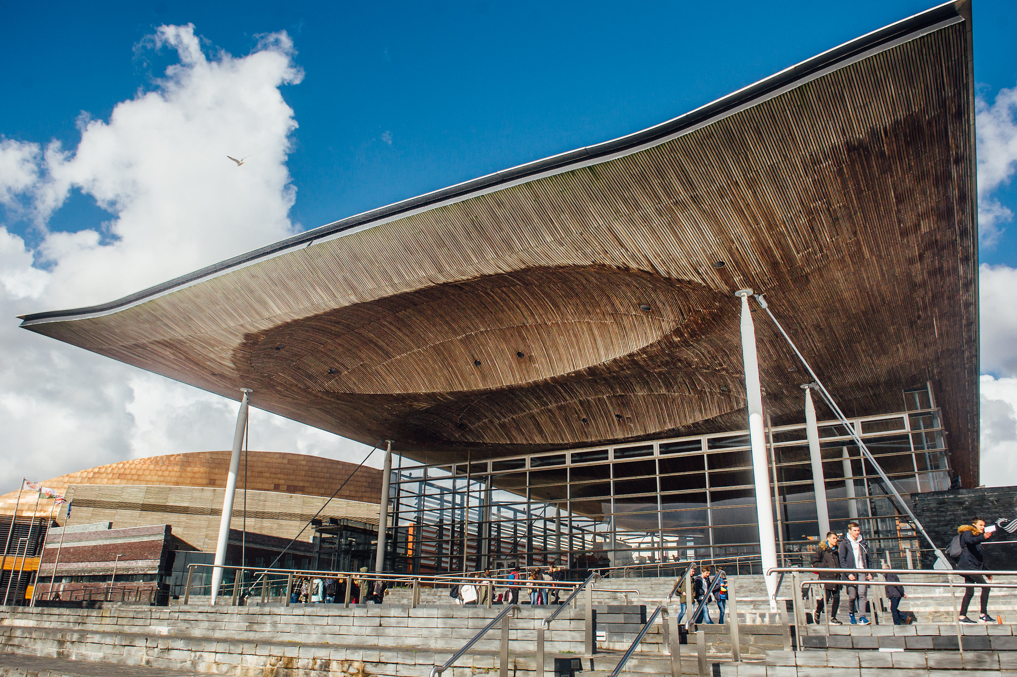 Campaigners welcome long overdue step forward for Welsh democracy with Senedd Reform.The image shows the Senedd seen from the outside under a clear blue sky. 