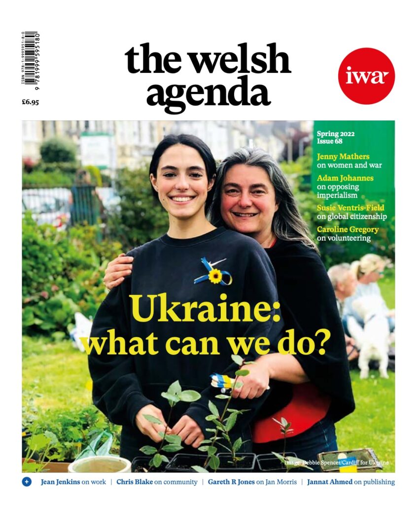 The cover of issue 68 of the welsh agenda, titled 'Ukraine: What can we do'. It portrays two women, one young and one older, hugging at a charitable event organised in solidarity with Ukraine in Cardiff.