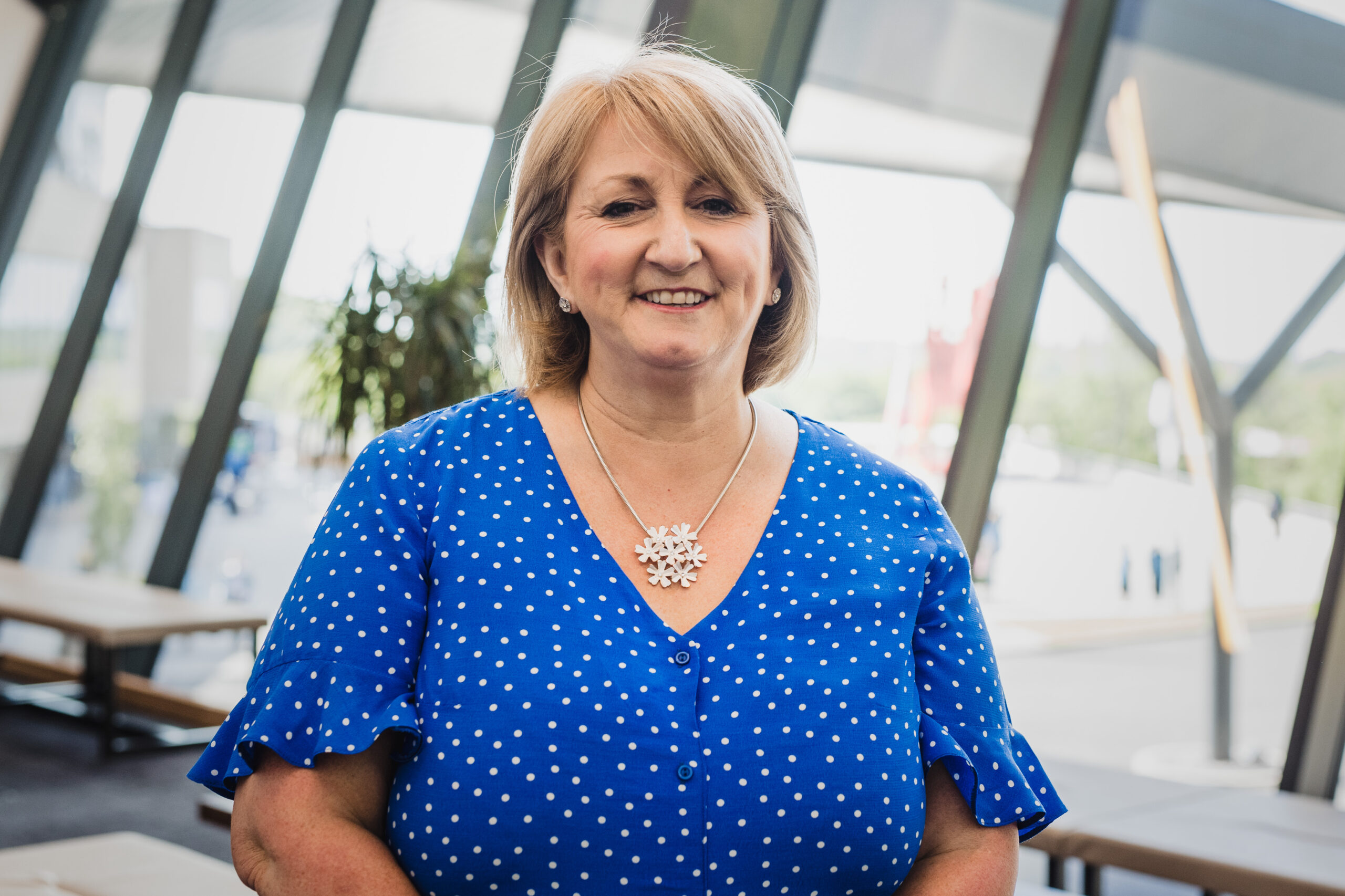 A picture of a white woman in a blue dress. Louise Casella is the director of the Open University, and in her article argues that more value should be placed on the collective social good of higher education.