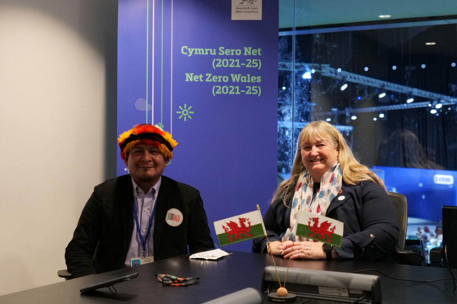 A picture of Climate Minister Julie James sitting next to one of the representatives from the Guarani and Wampís nations she met at COP26, during discussions on deforestation