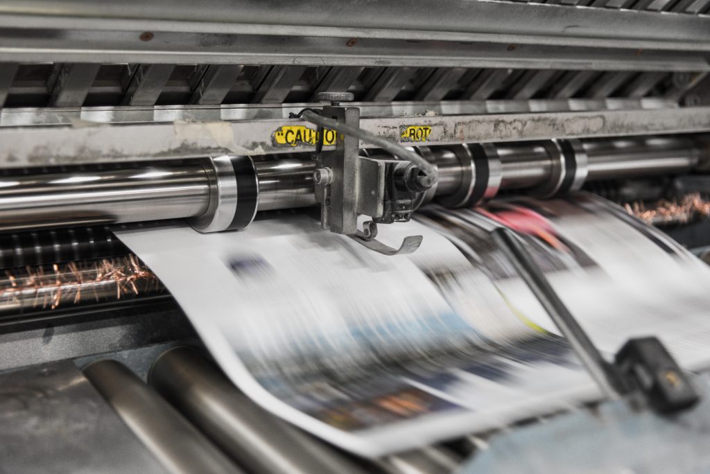 Hannah Watkin describes the challenges faced by new entrants to the journalism sector during the pandemic. The image shows a newspaper being printed.