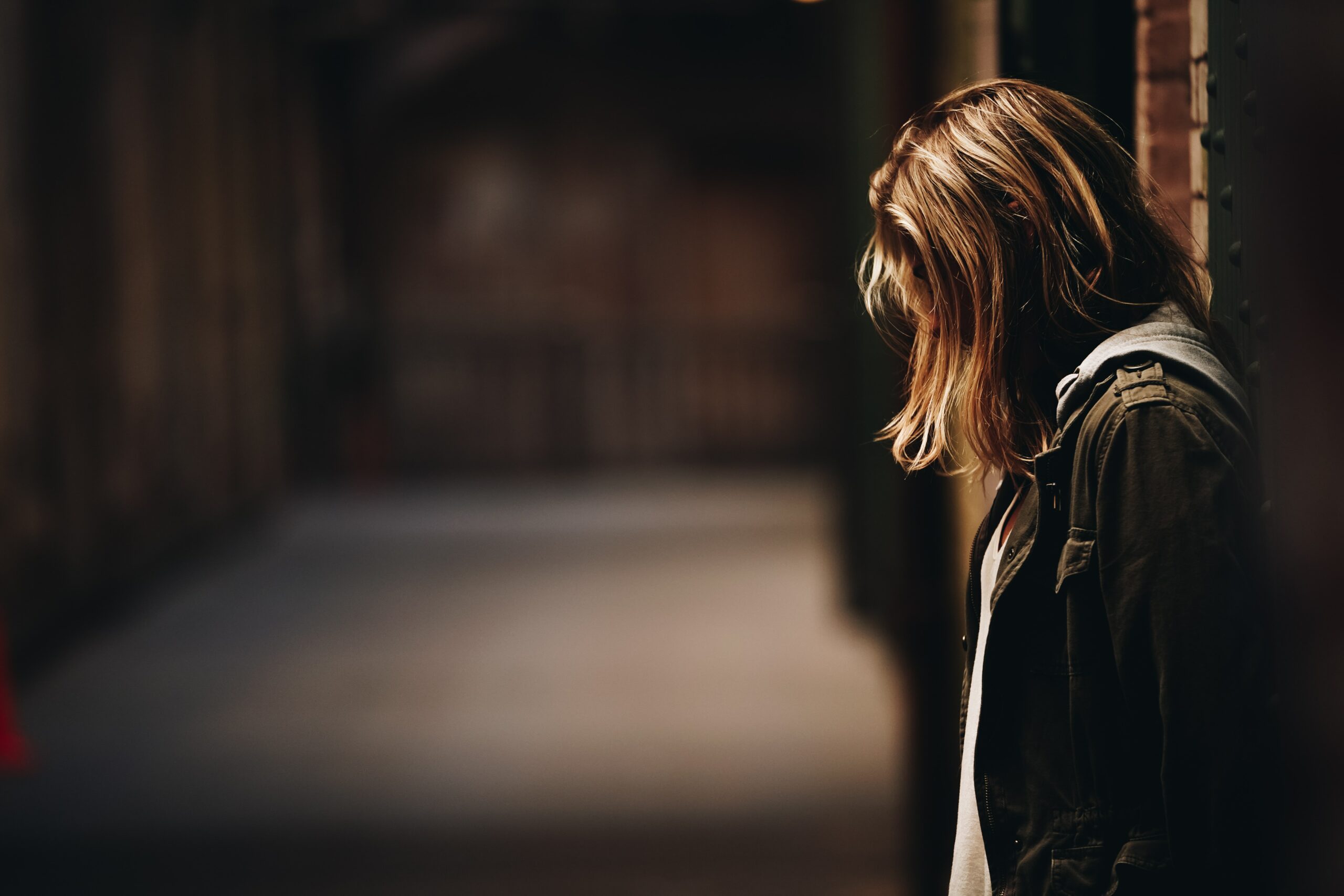 A girl holding her head, looking in distress