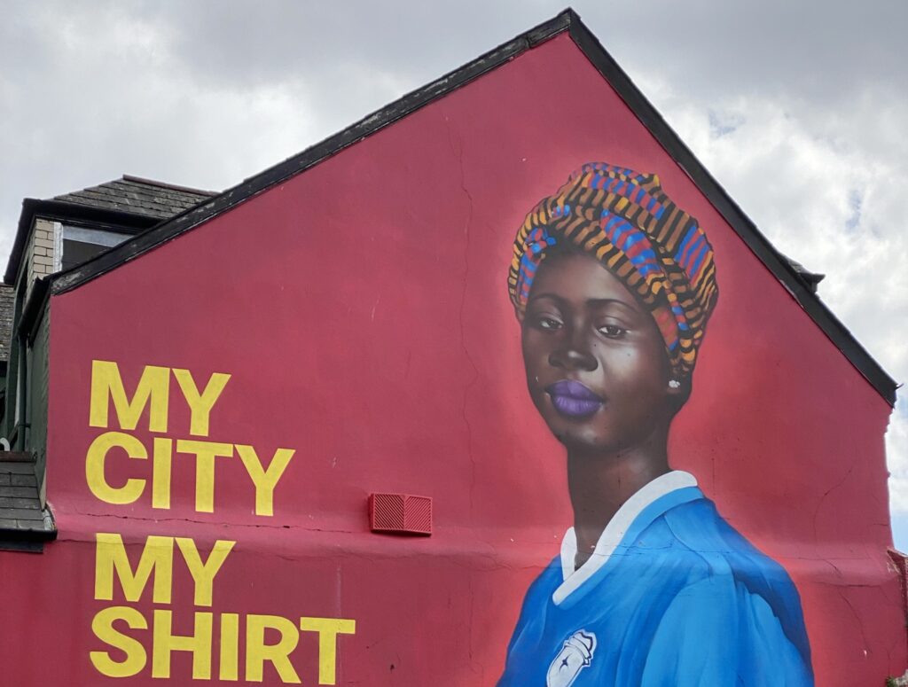 A picture of one of the My City My Shirt murals in Butetown, where the plot of The Fortune Men takes place.