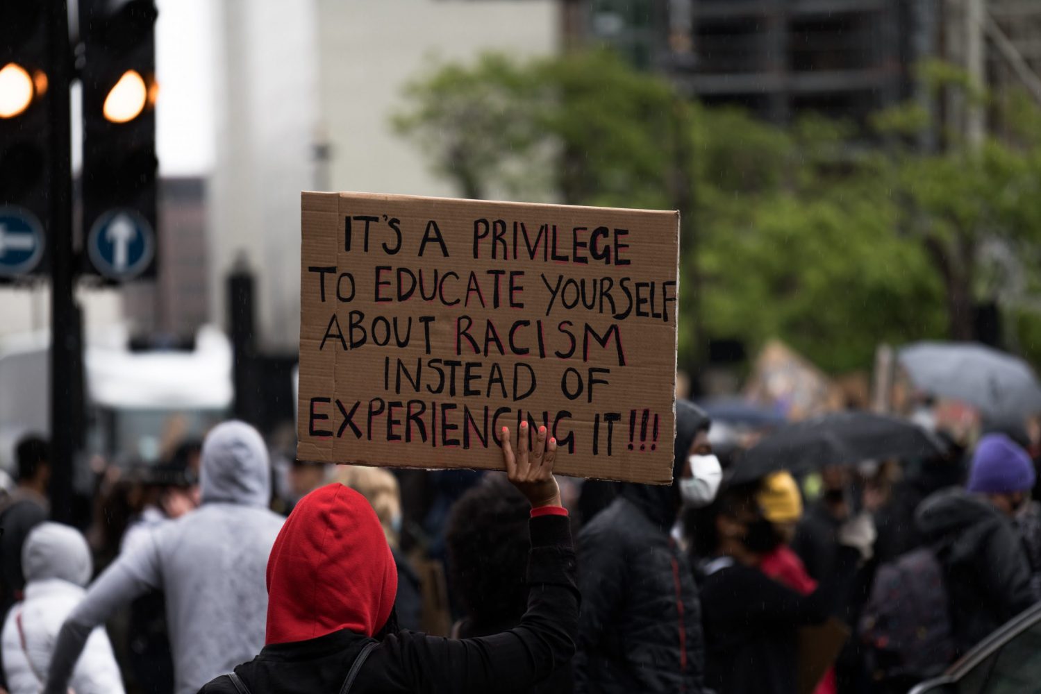 People holding an antiracist placard at a Black Lives Matter protest.