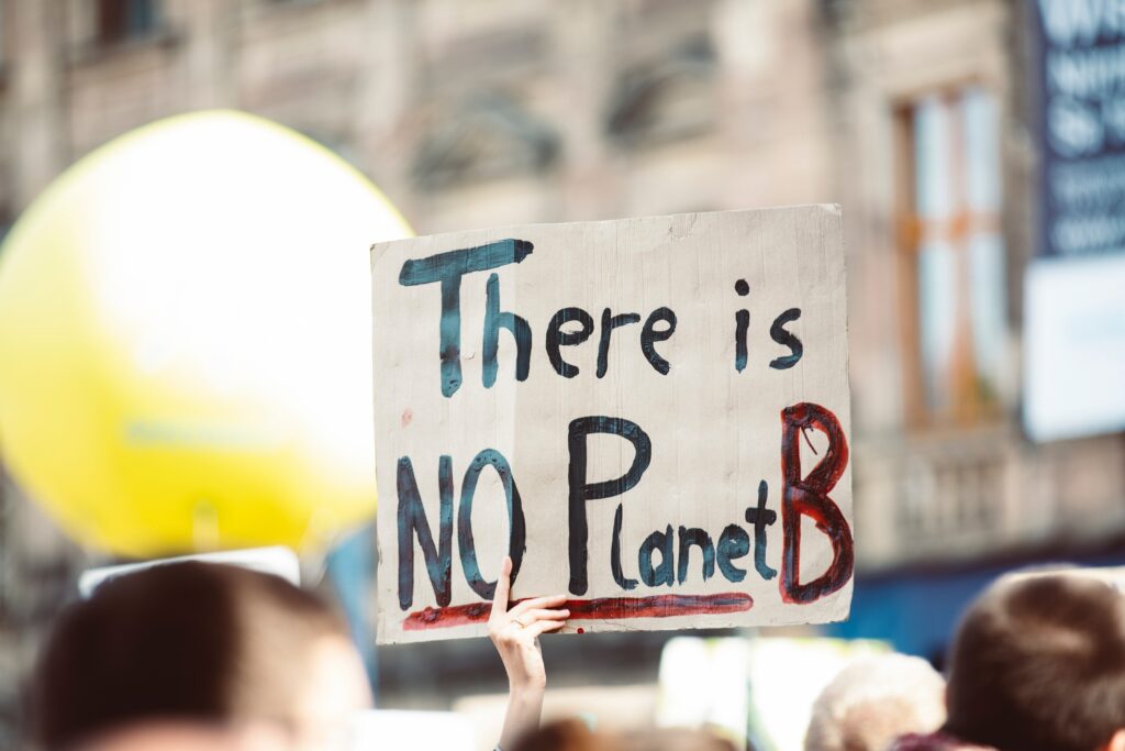 Joe Rossiter, the IWA’s Policy and External Affairs Manager, reflects ahead of COP28 on the state of climate and inequality The picture shows a protester holding a sign that says 'There is no planet B'