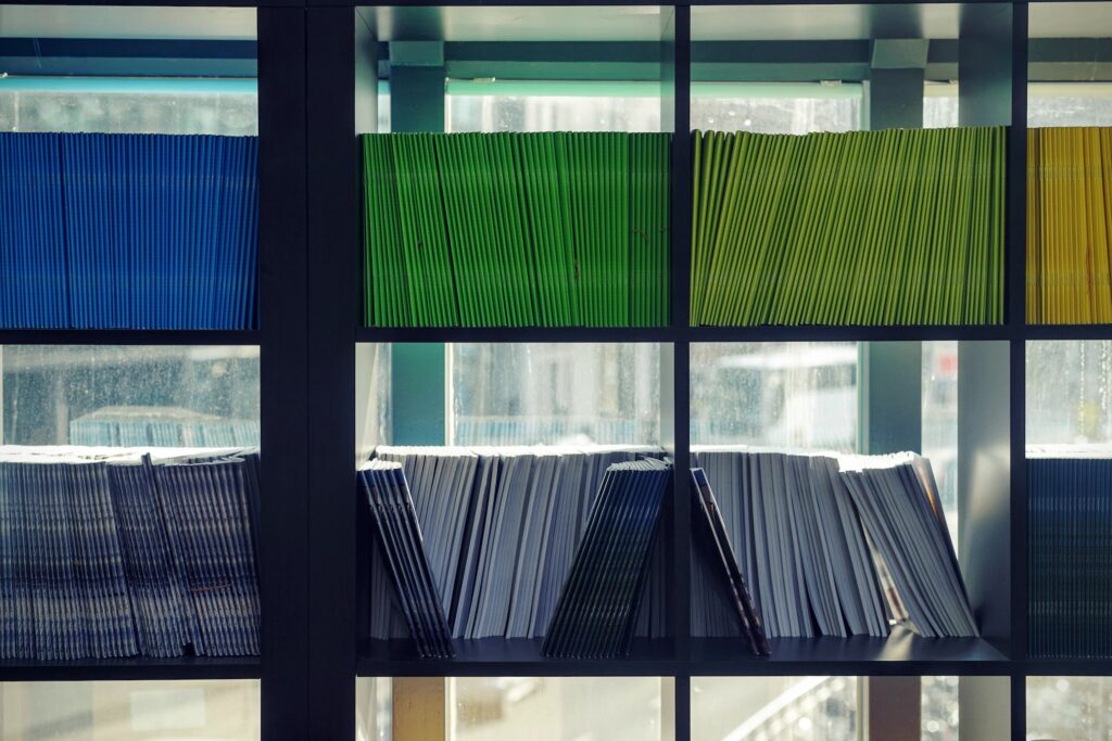 A bookshelf featuring 2 shelves of colourful magazines. In turbulent times, Martha O’Brien looks at the rise of Welsh publications and the impact this has on feelings of cultural identity.